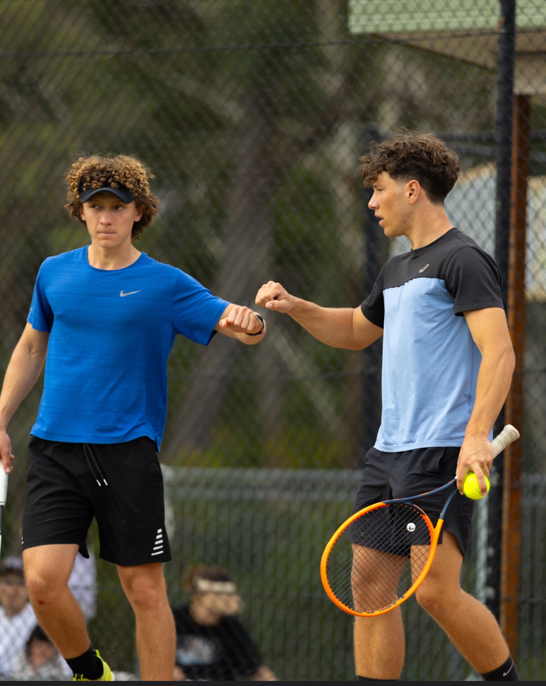 Alex and Adam fist-bumping mid-match